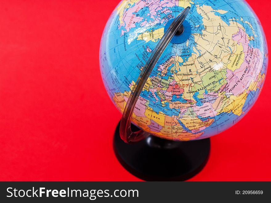 Close-up globe on red background
