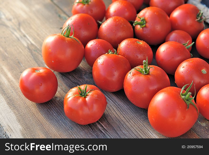 Tomatoes on a wooden table.