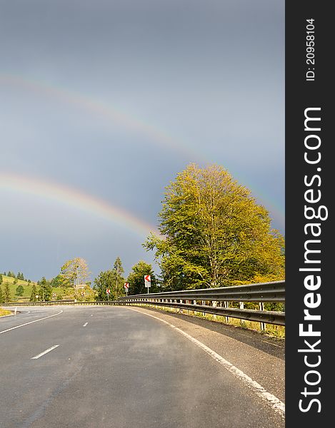 Empty road with rainbow above. Empty road with rainbow above