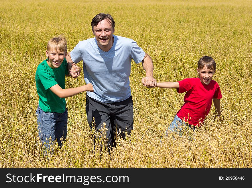 Happy dad with his sons at field. Happy dad with his sons at field