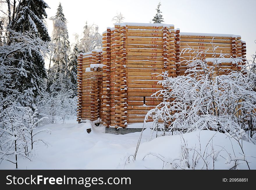 Unfinished abandoned wooden country house covered in snow in winter time. Unfinished abandoned wooden country house covered in snow in winter time