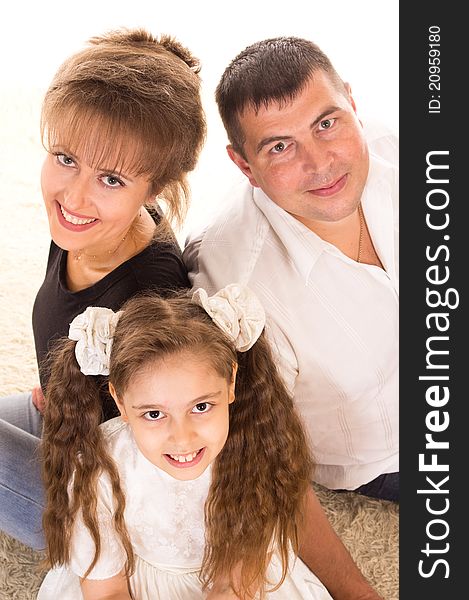 Portrait of a cute family on a carpet. Portrait of a cute family on a carpet