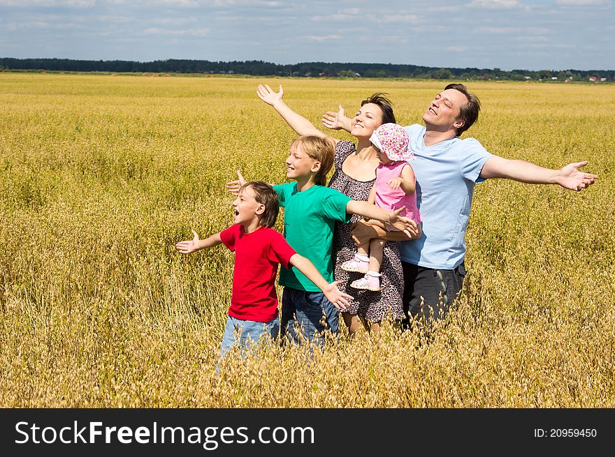 Cute family of a five playing at field. Cute family of a five playing at field