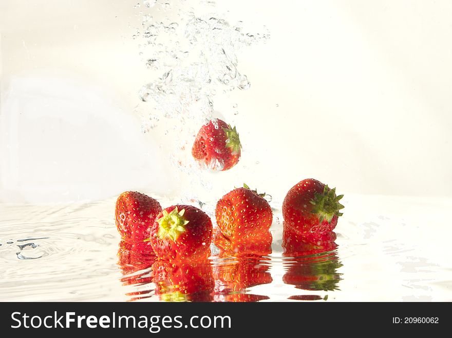 Strawberry in water,on white