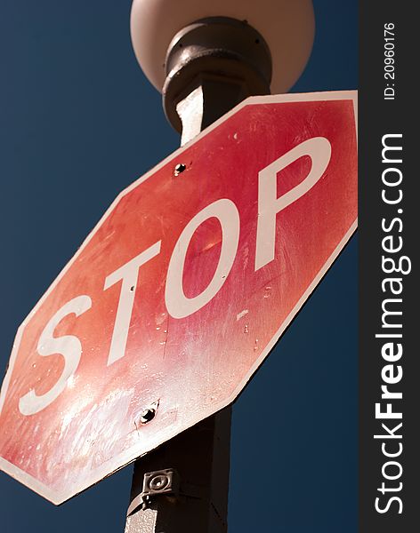 Stop sign shot from below with sunlight reflecting off bottom edge. Stop sign shot from below with sunlight reflecting off bottom edge.