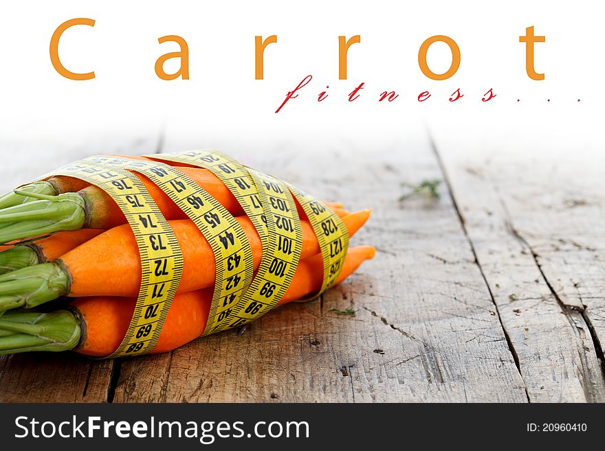 Fresh carrots with measure tape around, diet concept, place for your text up