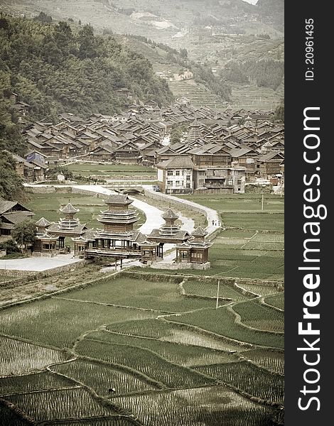 Aged image of Chinese Village on the rice terrace at sunset. View at mountain and rice terrace near the river. Aged image of Chinese Village on the rice terrace at sunset. View at mountain and rice terrace near the river.