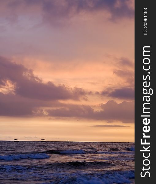 Image of exotic sky over sea at sunset. Increasing waves reflects sunlight with clouds. Image of exotic sky over sea at sunset. Increasing waves reflects sunlight with clouds.