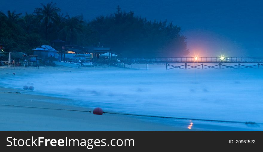 Image of Hainan beach with long pier early in the morning. Image of Hainan beach with long pier early in the morning.