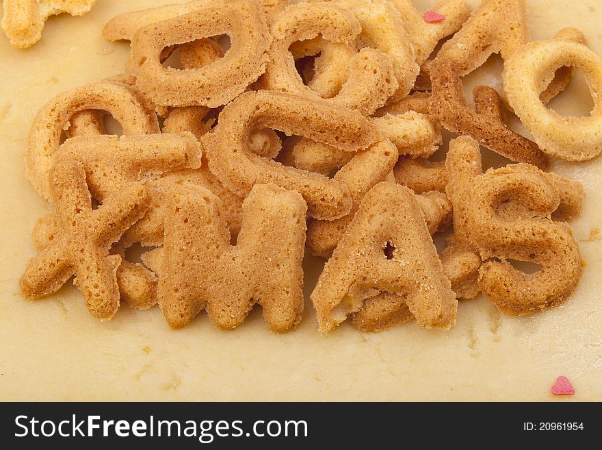 Studio-shot of preparing and baking cookies for christmas. baked letter biscuits spelling out the word xmas. Studio-shot of preparing and baking cookies for christmas. baked letter biscuits spelling out the word xmas.