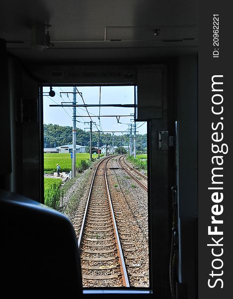 Looking out into the tracks from a moving train, just like looking forward into the future.