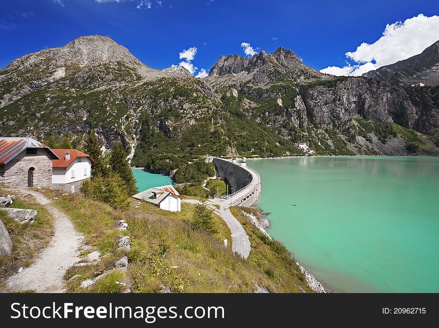 Dam and man-made lake between mountains. It’s Avio Lake, North of Italy, Lombardy region, at 1.923 meters on the sea-level. Dam and man-made lake between mountains. It’s Avio Lake, North of Italy, Lombardy region, at 1.923 meters on the sea-level