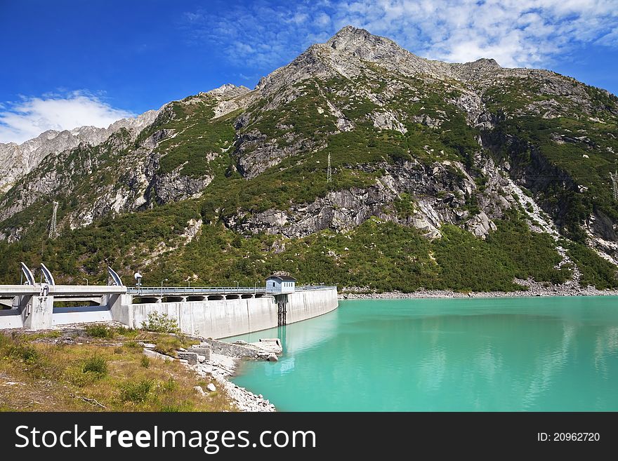 Dam and man-made lake between mountains. It’s Avio Lake, North of Italy, Lombardy region, at 1.923 meters on the sea-level. Dam and man-made lake between mountains. It’s Avio Lake, North of Italy, Lombardy region, at 1.923 meters on the sea-level