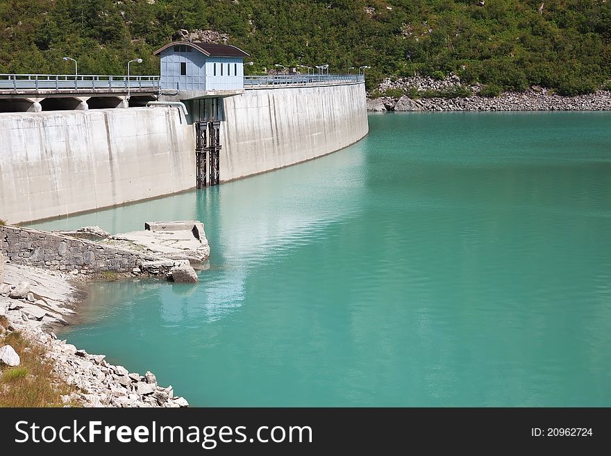 Dam and man-made lake between mountains. It’s Avio Lake, North of Italy, Lombardy region, at 1.923 meters on the sea-level. Dam and man-made lake between mountains. It’s Avio Lake, North of Italy, Lombardy region, at 1.923 meters on the sea-level