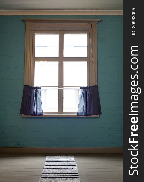 Old window with blue curtains in empty room. Old window with blue curtains in empty room