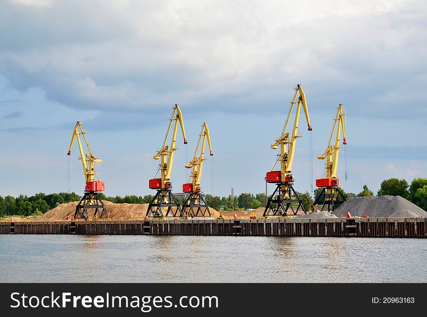 Cranes and sand hills on river port