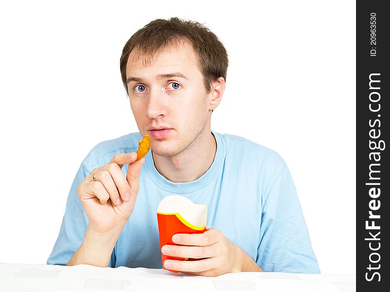 A young man with fries on a white