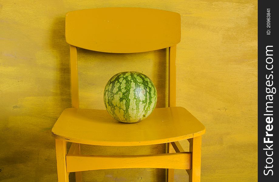 Watermelon on yellow chair and yellow background