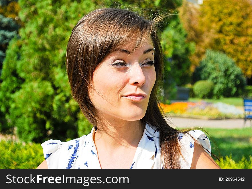 Beautiful girl making faces in the park. Beautiful girl making faces in the park