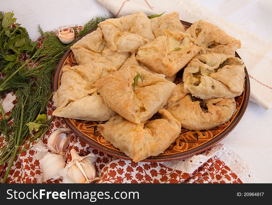 Tasty salty baking with cheese and fennel and with garlic on a dish on a napkin. Tasty salty baking with cheese and fennel and with garlic on a dish on a napkin