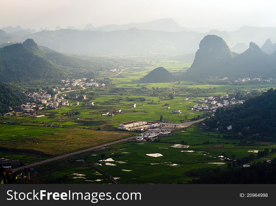 Aerial view image of Guilin village at sunset from Moon Hill mountain. Yangshuo, China, Asia. Aerial view image of Guilin village at sunset from Moon Hill mountain. Yangshuo, China, Asia