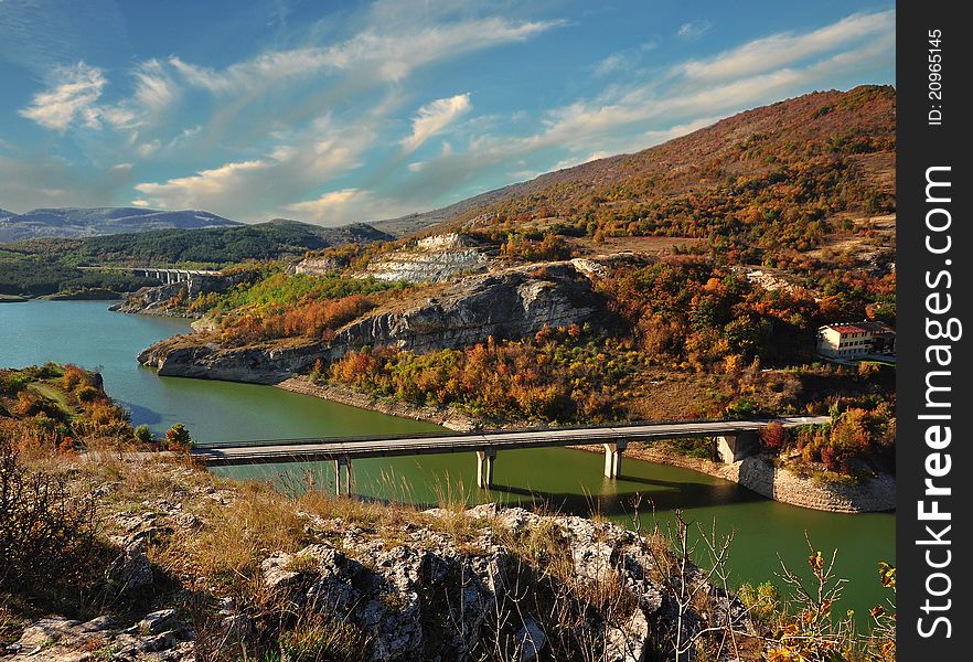 Autumn forest with blue river