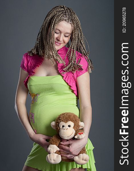 Beautiful pregnant girl with a toy