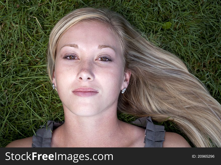 Beautiful young blond model lying on grass. Beautiful young blond model lying on grass