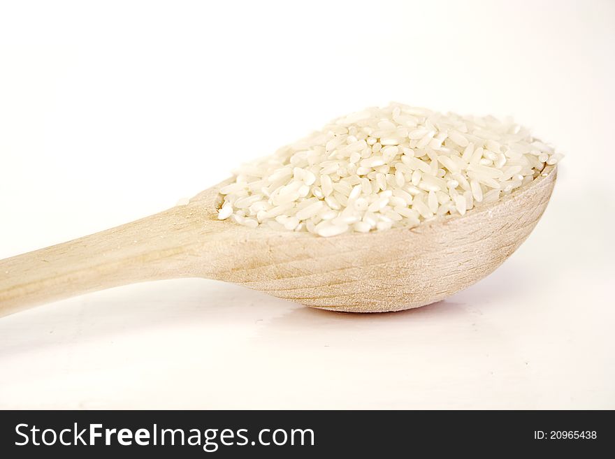 Wooden spoon filled with rice. Wooden spoon filled with rice