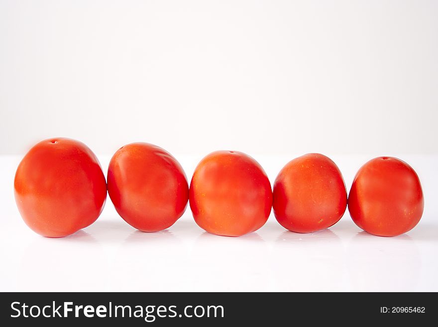 Five red tomatoes in studio. Five red tomatoes in studio