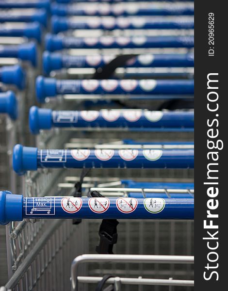 Shopping carts stacked up with blue handle