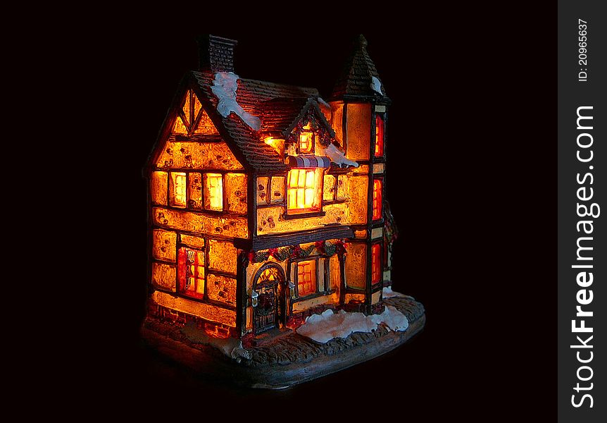 Illuminated house isolated on a black background