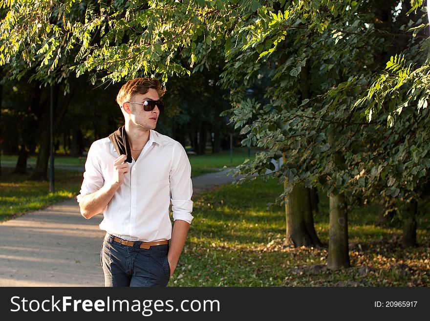 Portrait of male model in the park at sunrise walking around. Portrait of male model in the park at sunrise walking around