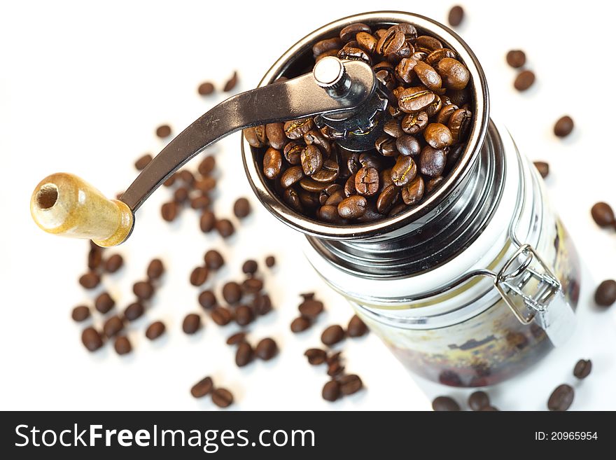 Manual coffee mill with coffee beans on white background. Manual coffee mill with coffee beans on white background