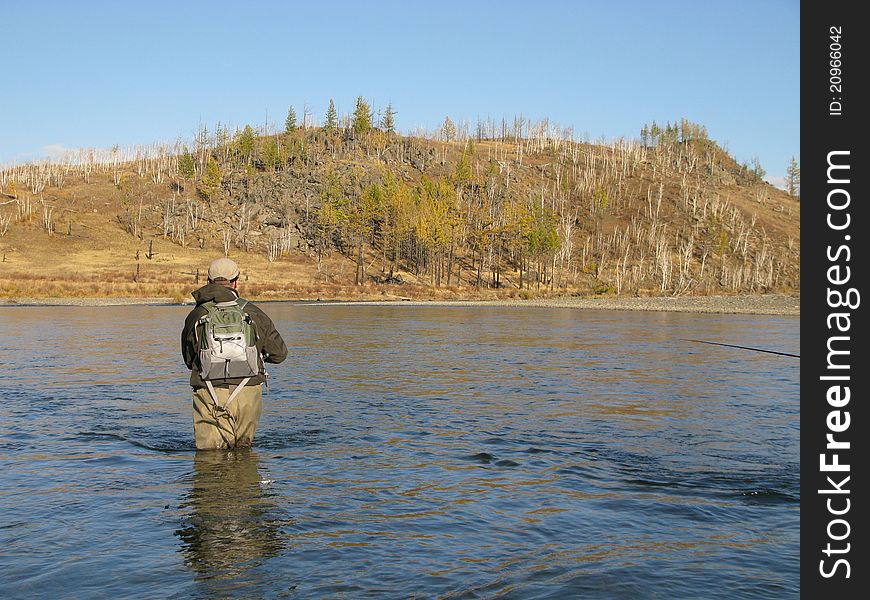 Fishing - fisherman on wild river