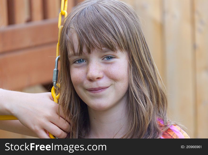 Young girl on a swing in summer