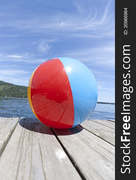 Colorful beachball on a dock