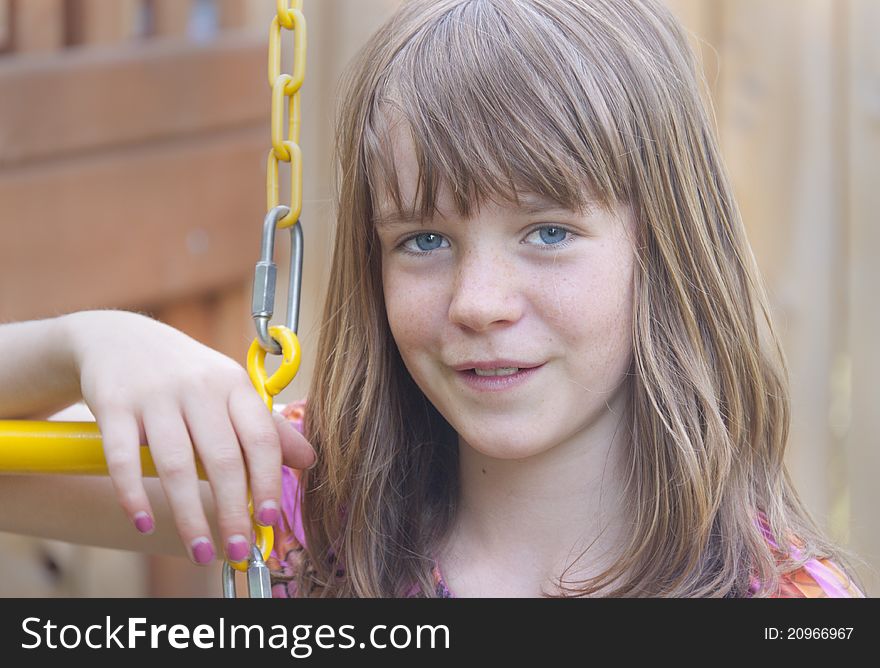 Young Teenage Girl On A Swing