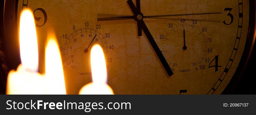 Blured candles on the background clock. Blured candles on the background clock