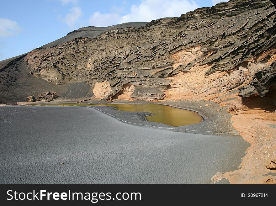 View of a green lake on a rocky landscape (Lanzarote). View of a green lake on a rocky landscape (Lanzarote)