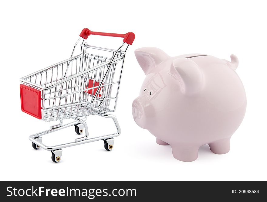 Piggy bank with shopping cart on white