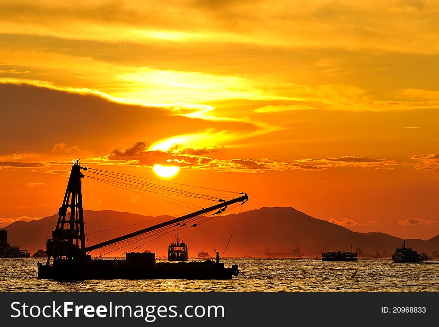 Cargo ship sail into the sunset on Victoria Harbour. Cargo ship sail into the sunset on Victoria Harbour