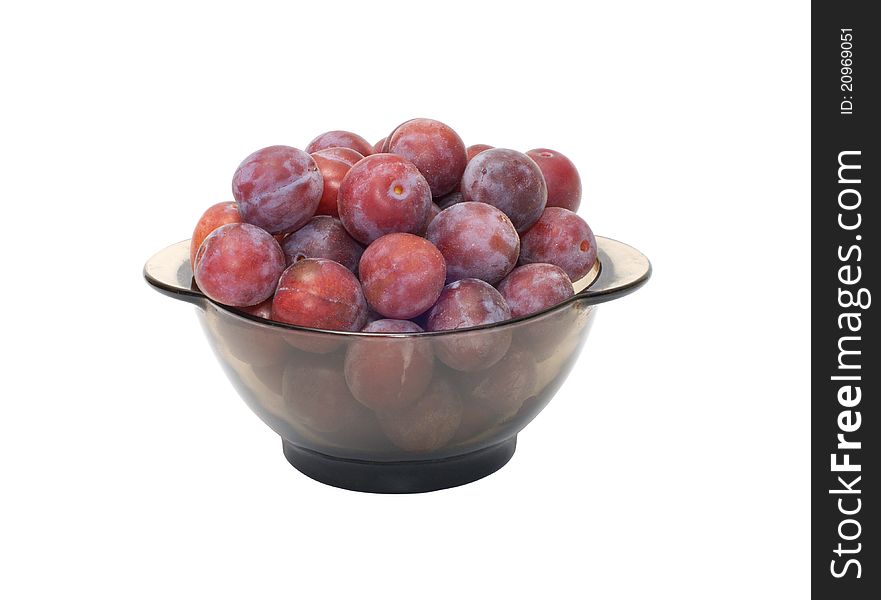 Ripe plums on a plate isolated on a white background. Ripe plums on a plate isolated on a white background.
