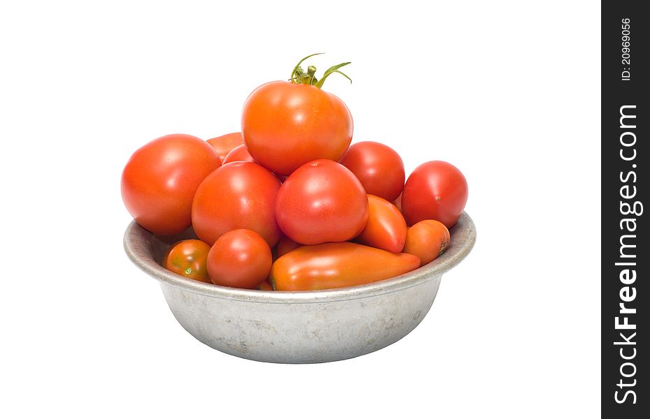 Tomatoes in an aluminum bowl, isolated on a white background. Tomatoes in an aluminum bowl, isolated on a white background.
