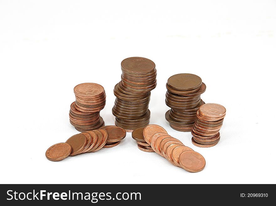 Copper coins of little value stacked on a white background. Copper coins of little value stacked on a white background