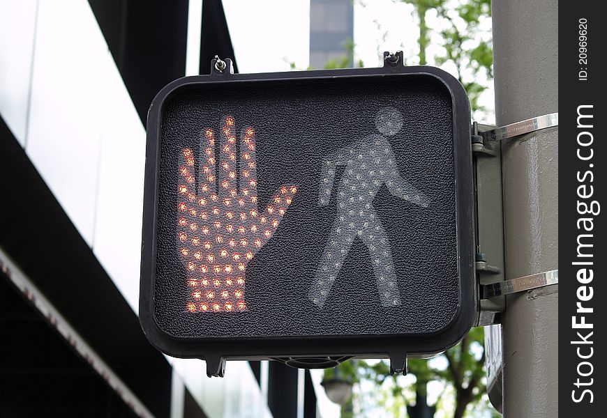 Modern crossing sign with stop hand showing. Modern crossing sign with stop hand showing.