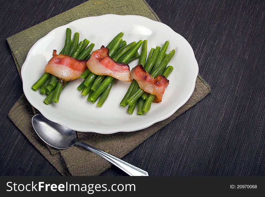 Three portions of Green beans wrapped in bacon