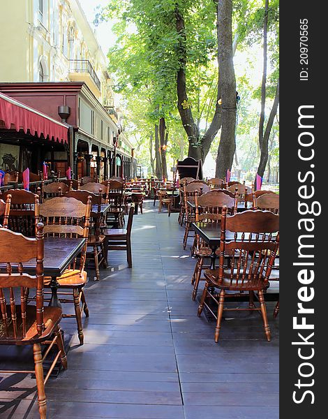 Empty sidewalk restaurant is photographed with diminishing perspective early in the morning. Empty sidewalk restaurant is photographed with diminishing perspective early in the morning.