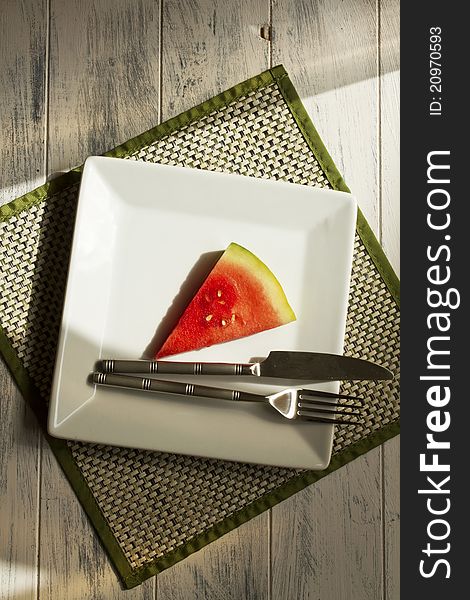Melon slice on a white plate. Melon slice on a white plate