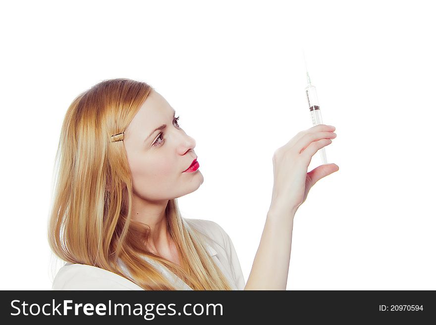 Pretty nurse with syringe in medical white uniform